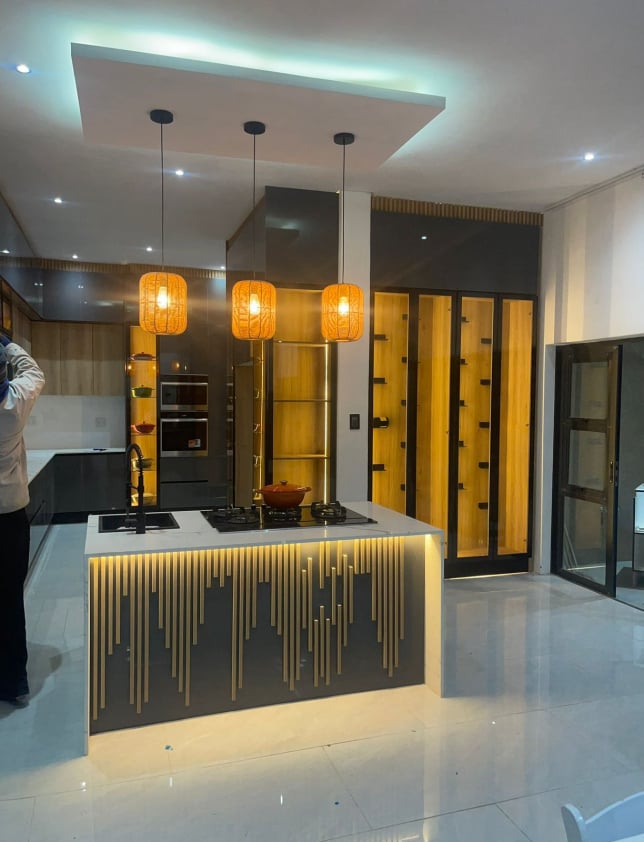 Kitchen island with pendant lights and slatted detail